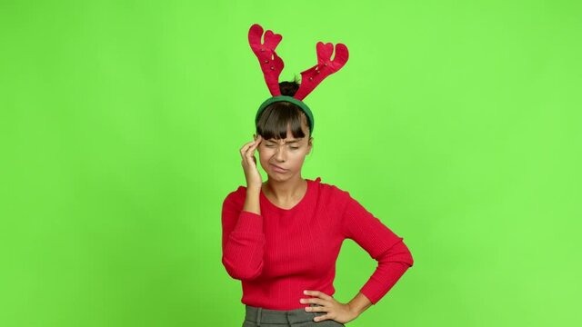 Young woman wearing christmas hat unhappy and frustrated with something over isolated background. Green screen chroma key