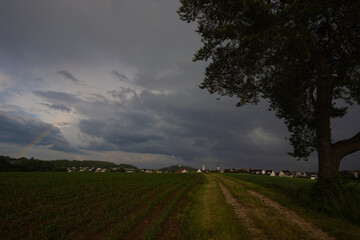 Fototapeta na wymiar Thunderstorm with rainbow over Sulzbach Rosenberg city