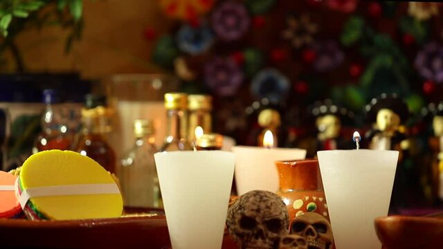 Celebration of the Day of the Dead in Mexico.Hand lighting candle in traditional mexican offering