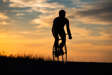 cyclist silhouette at sunset sports and fitness concept