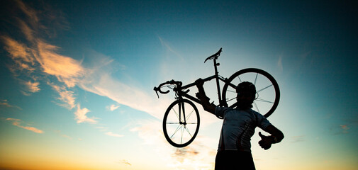cyclist silhoutte with bicycle raised to sky race and victory concept - obrazy, fototapety, plakaty