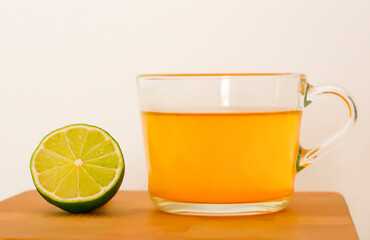 yellow tea with lime on a wooden board