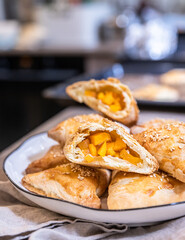 Puff pastry buns with pumpkin sprinkled with sesame seeds. Homemade autumn pastries.