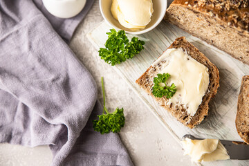 Freshly baked artisan multigrain bread with butter and pate. Breakfast with coffee, sliced bread, butter and liver pate.