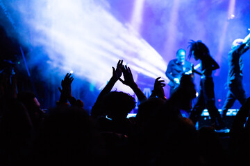 Fototapeta premium crowd at concert and silhouettes in stage lights