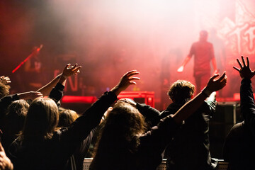 crowd at concert and silhouettes in stage lights