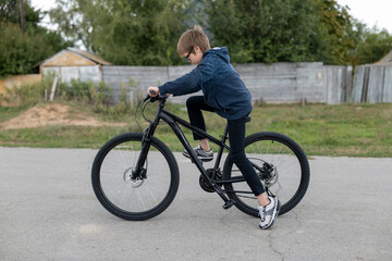 Cute boy on new bike posing on different background