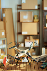 Fototapeta na wymiar desk with parcels and drone in warehouse