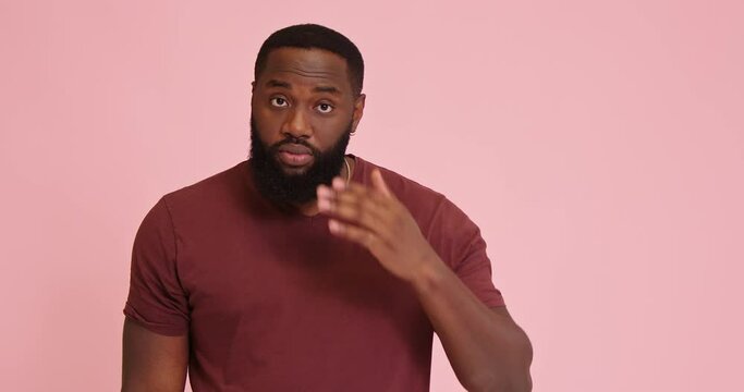 Young African american man touch eyebrows on pink background