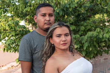 Portrait of a serious Hispanic couple in the park