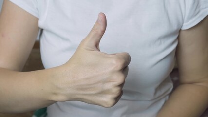 Female woman hand showing thumb up, like gesture close up