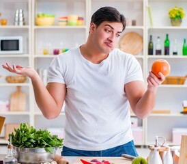 Young male cook working in the kitchen