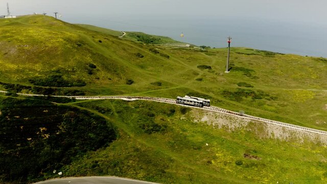 Aerial view of Llandudno from the top of great orme summit cable car station, cable carts crossing paths