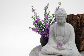 Stone Buddha and flowers. 