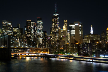 View of lower Manhattan and Financial district at night. Skyscrapers with lights on in New York City