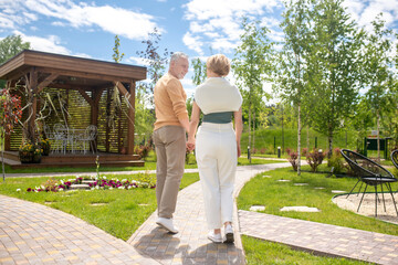 Man and his wife strolling hand in hand