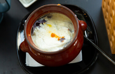 Delicious dumplings in a pot, baked with cream. Close-up image