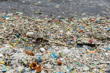 a lot of trash on the shore of manila bay in malate where is the commercial district in metro manila, the philippines