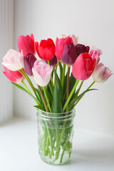 bouquet of pink tulips in mason jar