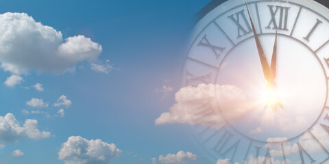 Double exposure of clock face in blue sky. Time passing concept.