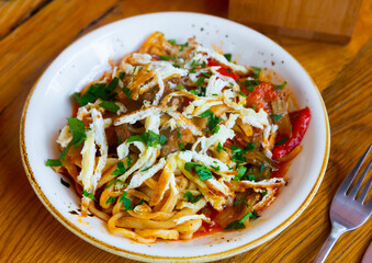 Traditional kaurma laghman noodles fried with vegetables, lamb and omelette. Popular asian dish