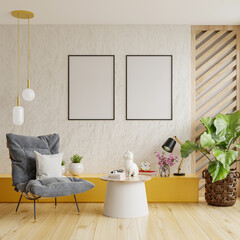 Two vertically framed poster mockups on an empty white wall in a living room decor with an armchair.