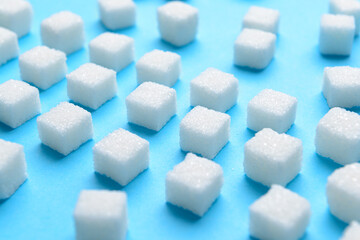 Cubes of sweet sugar on blue background
