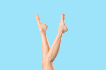 Legs of beautiful woman on color background