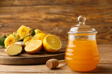 Sweet honey, ginger and lemon on wooden table