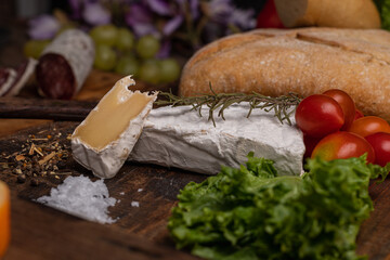 minced board with meat sausages salami cheese brie almonds and fruit