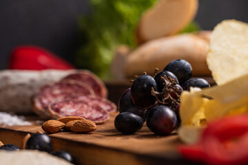 star anise meat table sausage almonds and grapes cheese