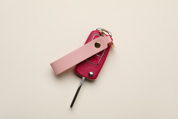 Car key with leather keychain on light background