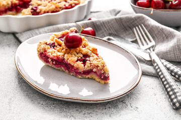 Plate with piece of tasty cherry pie on light background, closeup