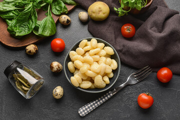 Composition with tasty gnocchi on dark background