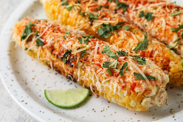 Plate with tasty Elote Mexican Street Corn on table, closeup