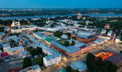 Scenic aerial view of Yaroslavl cityscape on bank of Volga River overlooking golden domes of Assumption Cathedral in background in summer twilight, Russia.