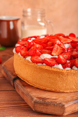 Board with tasty strawberry pie on table