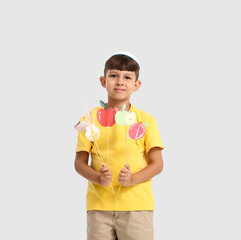 Little boy with decor for Rosh Hashanah (Jewish New Year) on white background