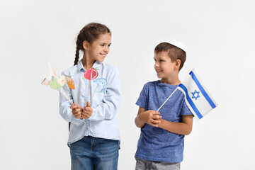 Little children with flag of Israel and decor for Rosh Hashanah (Jewish New Year) on white background