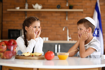 Little children celebrating Rosh Hashanah (Jewish New Year) at home