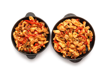 Frying pans with delicious Fajita on white background