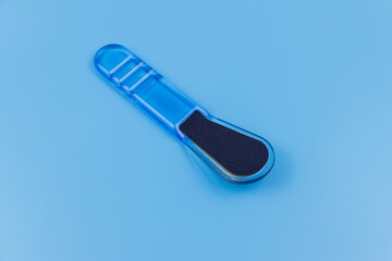 Blue pedicure grater on blue background