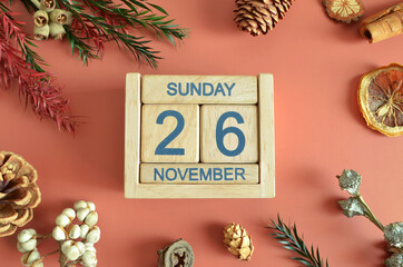November 26, Cover design with calendar cube, pine cones and dried fruit in the natural concept.