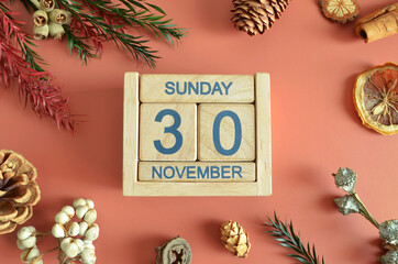 November 30, Cover design with calendar cube, pine cones and dried fruit in the natural concept.