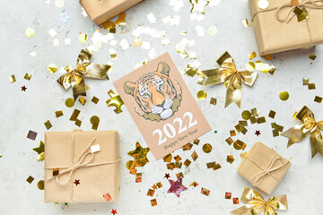 Fototapeta na wymiar Greeting card for New Year 2022 celebration with gifts on light background