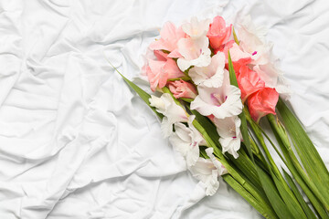 Gorgeous gladiolus flowers on light fabric background