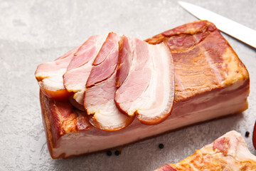 Tasty smoked bacon on light background