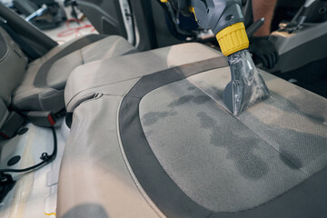 Close-up professional dry cleaning of car seat. Washing vacuum cleaner