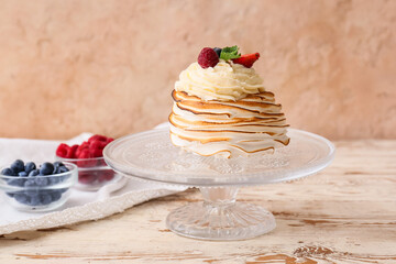 Dessert stand with tasty Pavlova cake on table