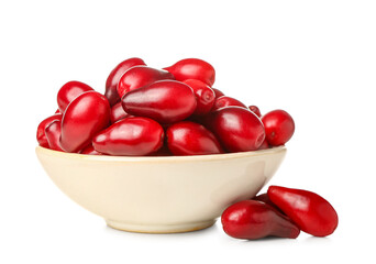 Bowl with fresh dogwood berries on white background